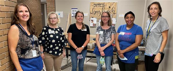 L-R Suzanne Phillips, Tammy Harvey, Ashley Coppins, Stephanie Gottler, Mary Harris, Rebecca Marte and other volunteers serve Subway on Thursday.